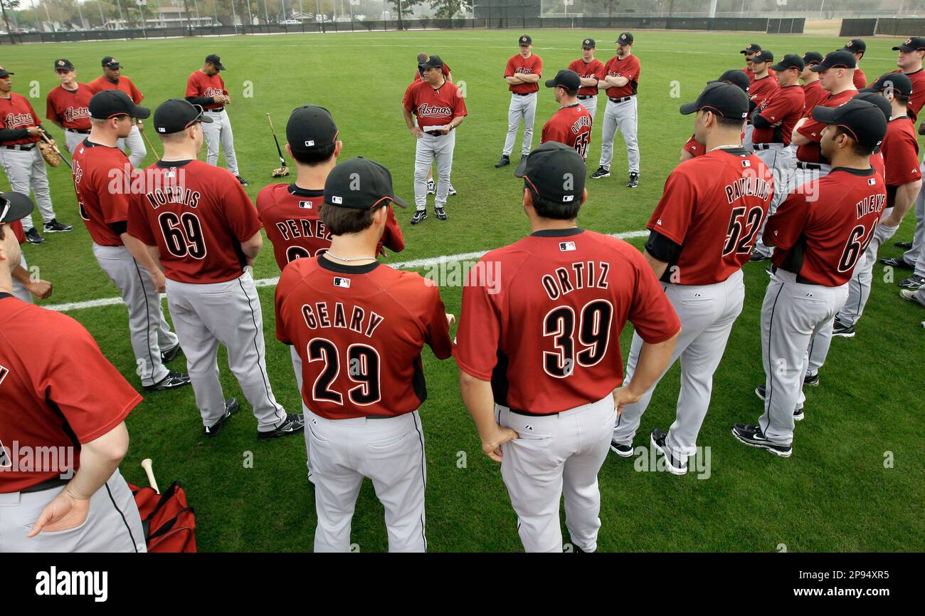 Houston Astros first base coach Ed Romero, center, gives instructions