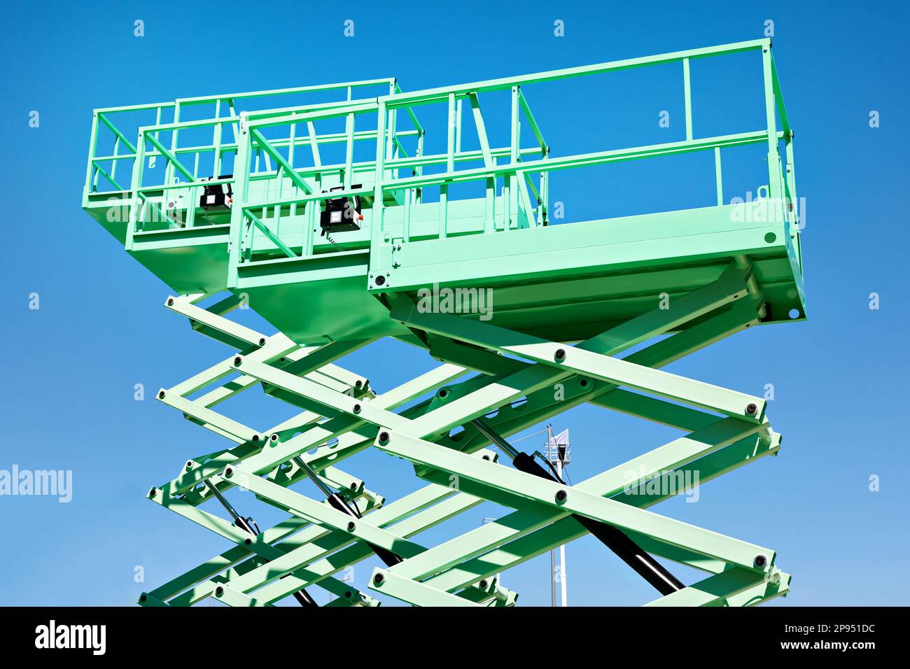 Construction scissor lifts on sky Stock Photo