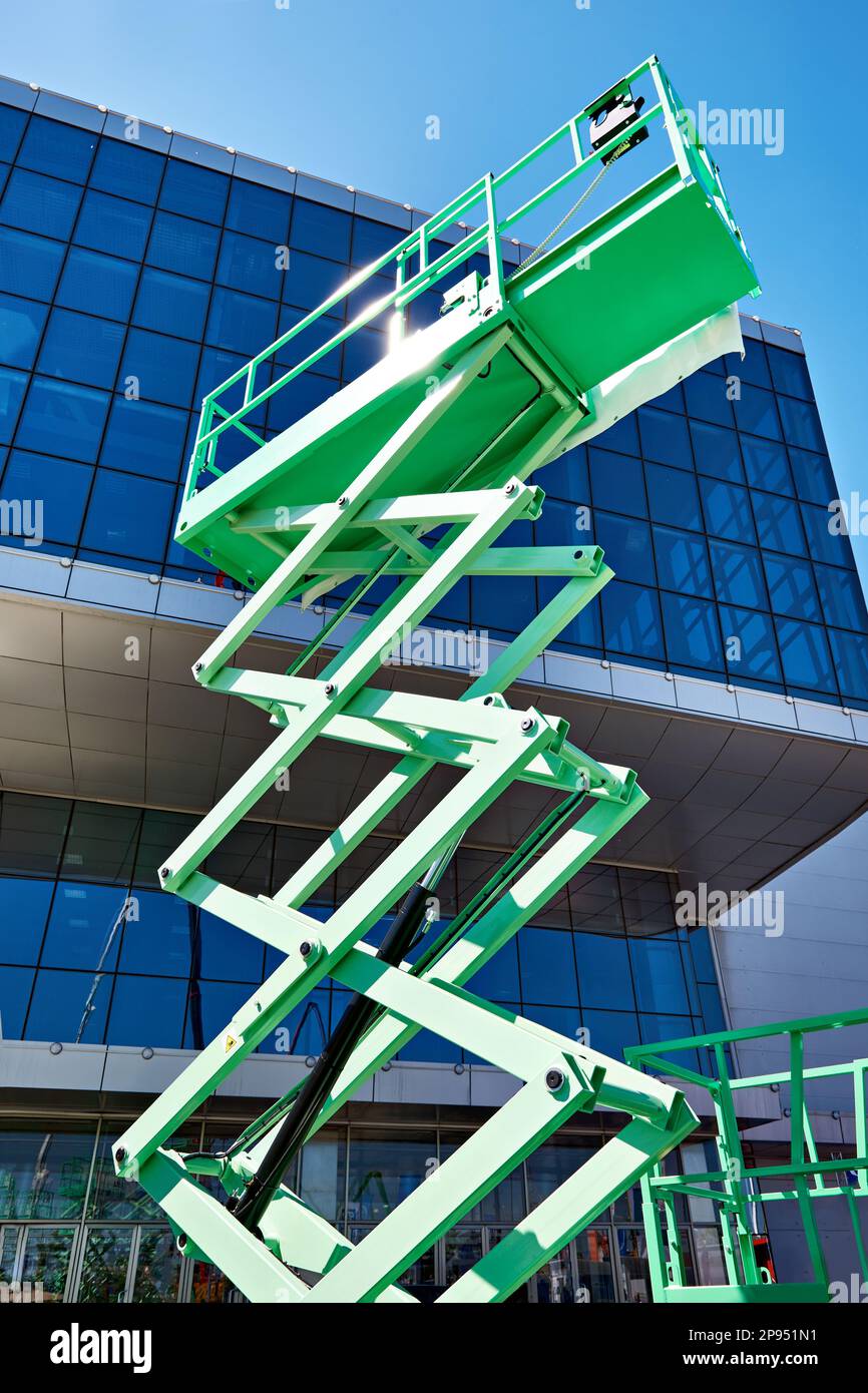 Construction scissor lifts on sky Stock Photo