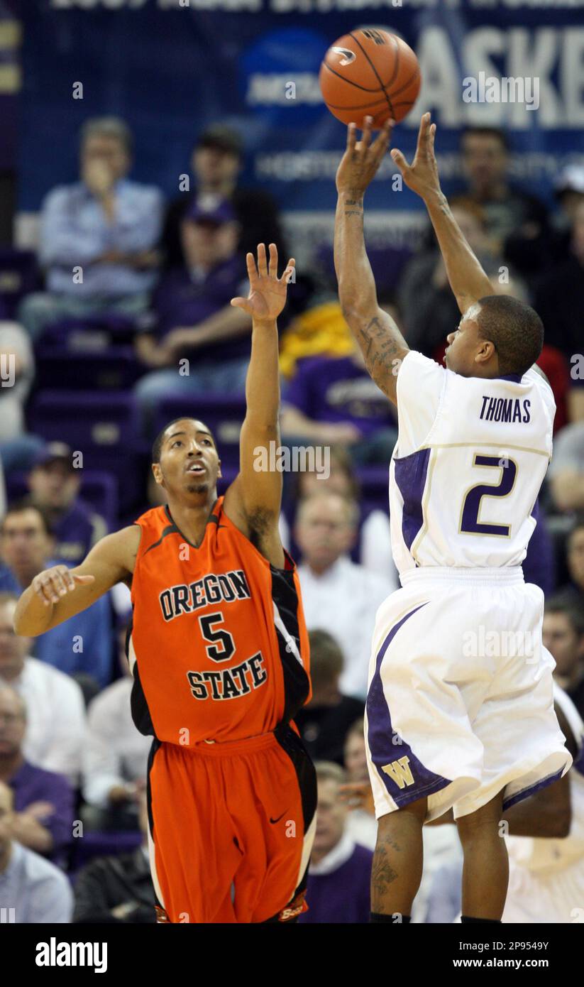 Washington's Isaiah Thomas, right, shoots over Oregon State's Josh ...