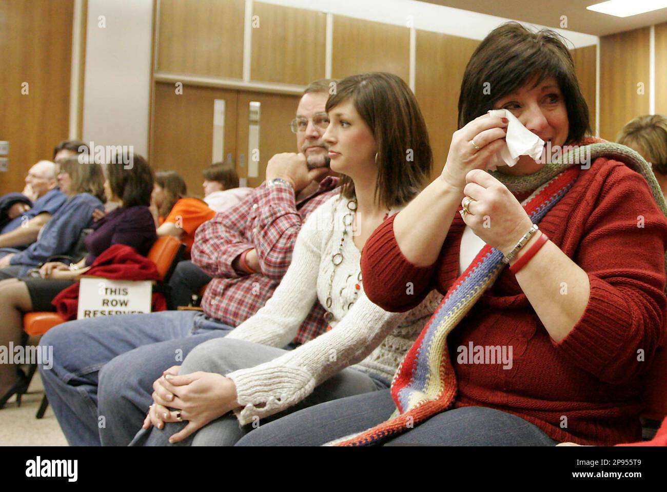 Cindy Sanderholm, right, her daughter Jennifer and husband Brian listen as Justin Thurber is convicted of capital murder Wednesday, Feb. 12, 2009 at the Cowley County Courthouse in Winfield, Kan. Thurber was charged with murder of Jodi Sanderholm, Brian and Cindy's daughter.(AP Photo/Alex Gambill, Pool) Stock Photo