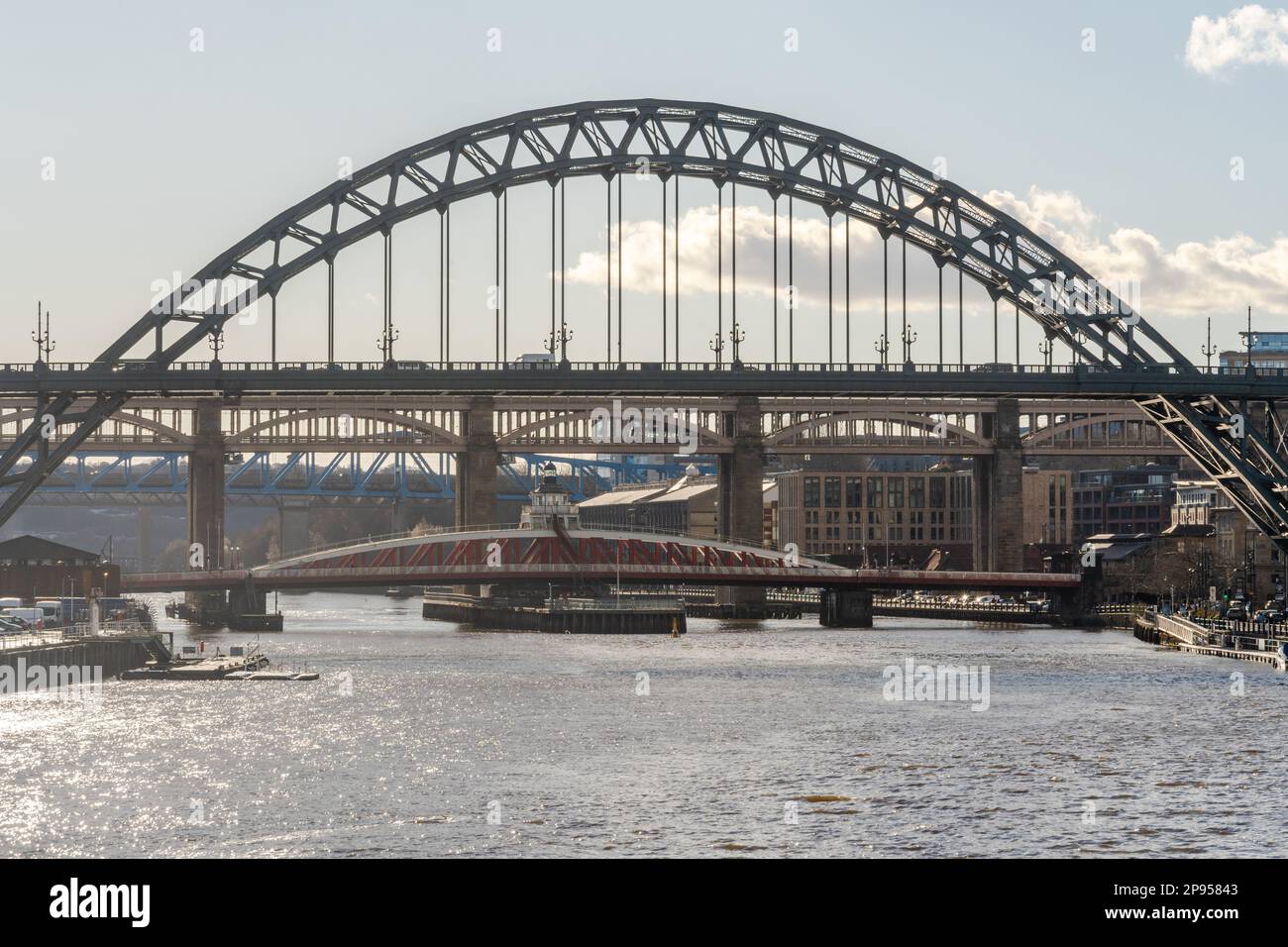 View of the Tyne Bridge crossing the river to Gateshead, with the Swing, High Level and Queen Elizabeth II bridges aligned. Newcastle upon Tyne, UK. Stock Photo
