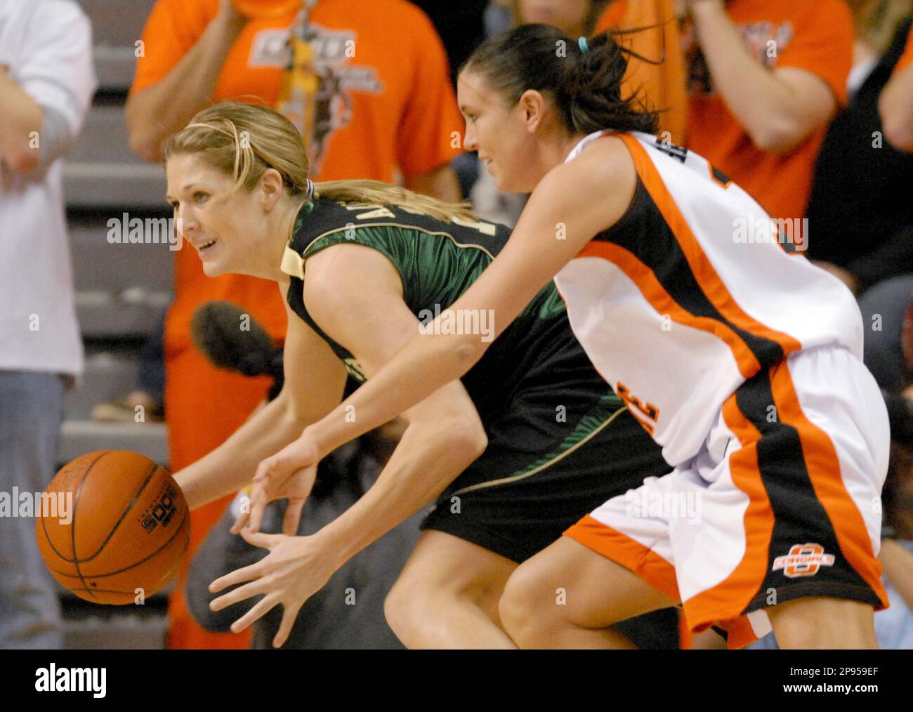Oklahoma State guard Taylor Hardeman, right, attempts to knock the ball