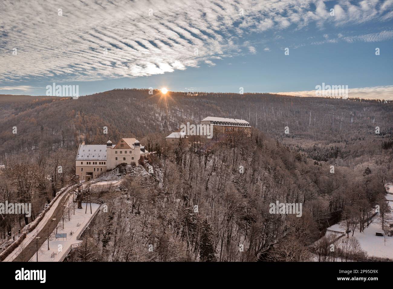 Germany, Thuringia, Schwarzburg, baroque castle, armory, road, river, forest, mountains, sunrise, snow, overview, back light Stock Photo