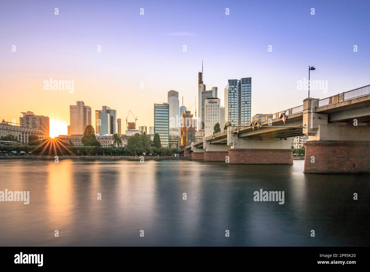 View over the river Main to the skyline of Frankfurt am Main. Sunset behind the skyscrapers of