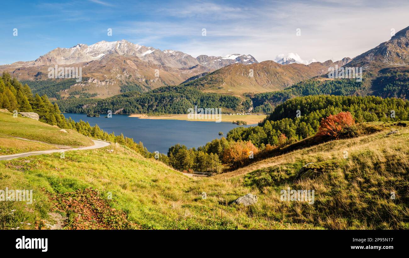 The hiking trail from Plaun da Lej to Grevasalvas (part of via engiadina) offers great views on Lake Sils and the Upper Engadine Valley (Switzerland). Stock Photo