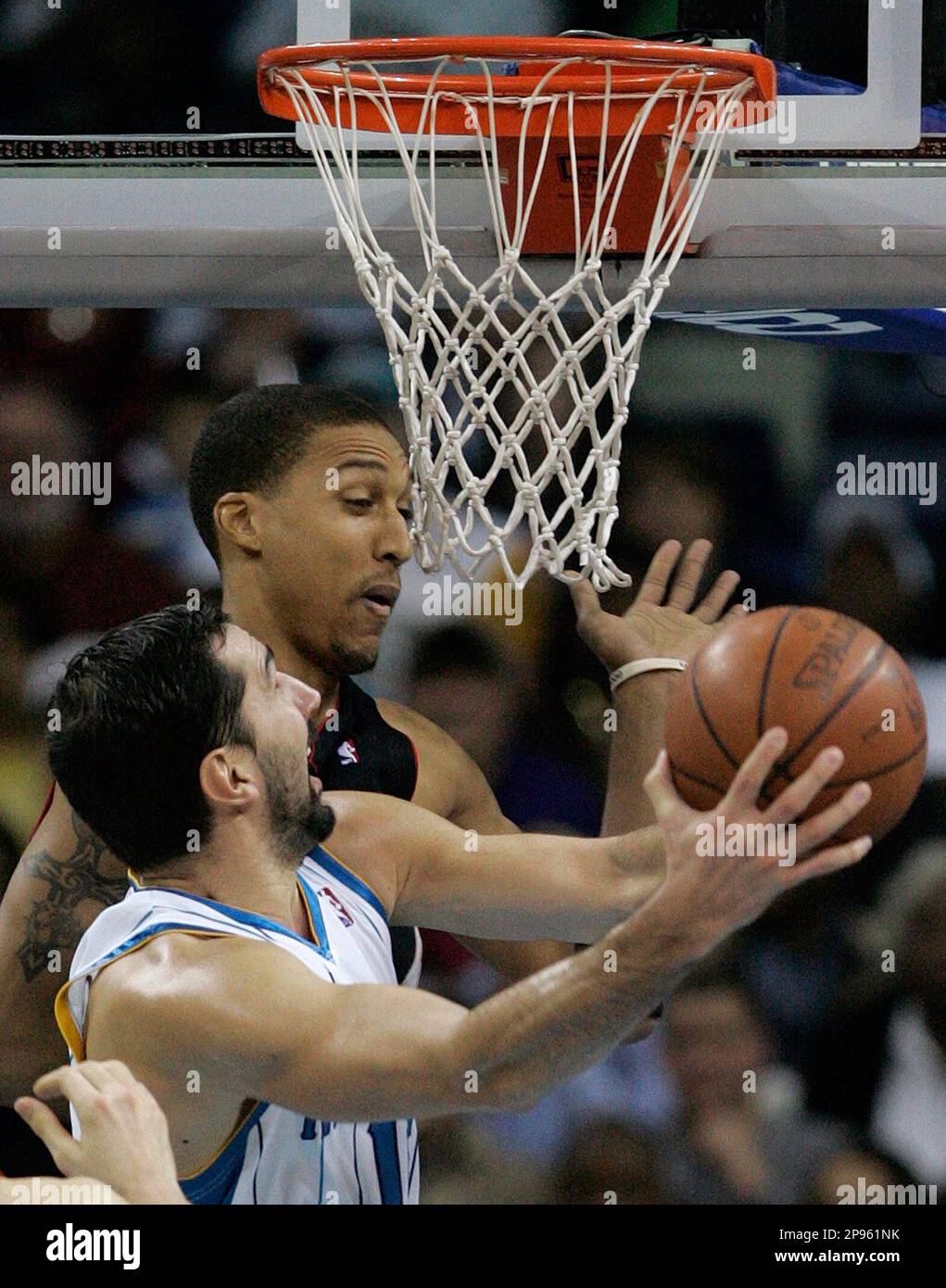 New Orleans Hornets forward Peja Stojakovic, front, of Serbia, goes to the  basket around Toronto Raptors forward Jamario Moon in the second half of  their NBA basketball game in New Orleans, Friday,