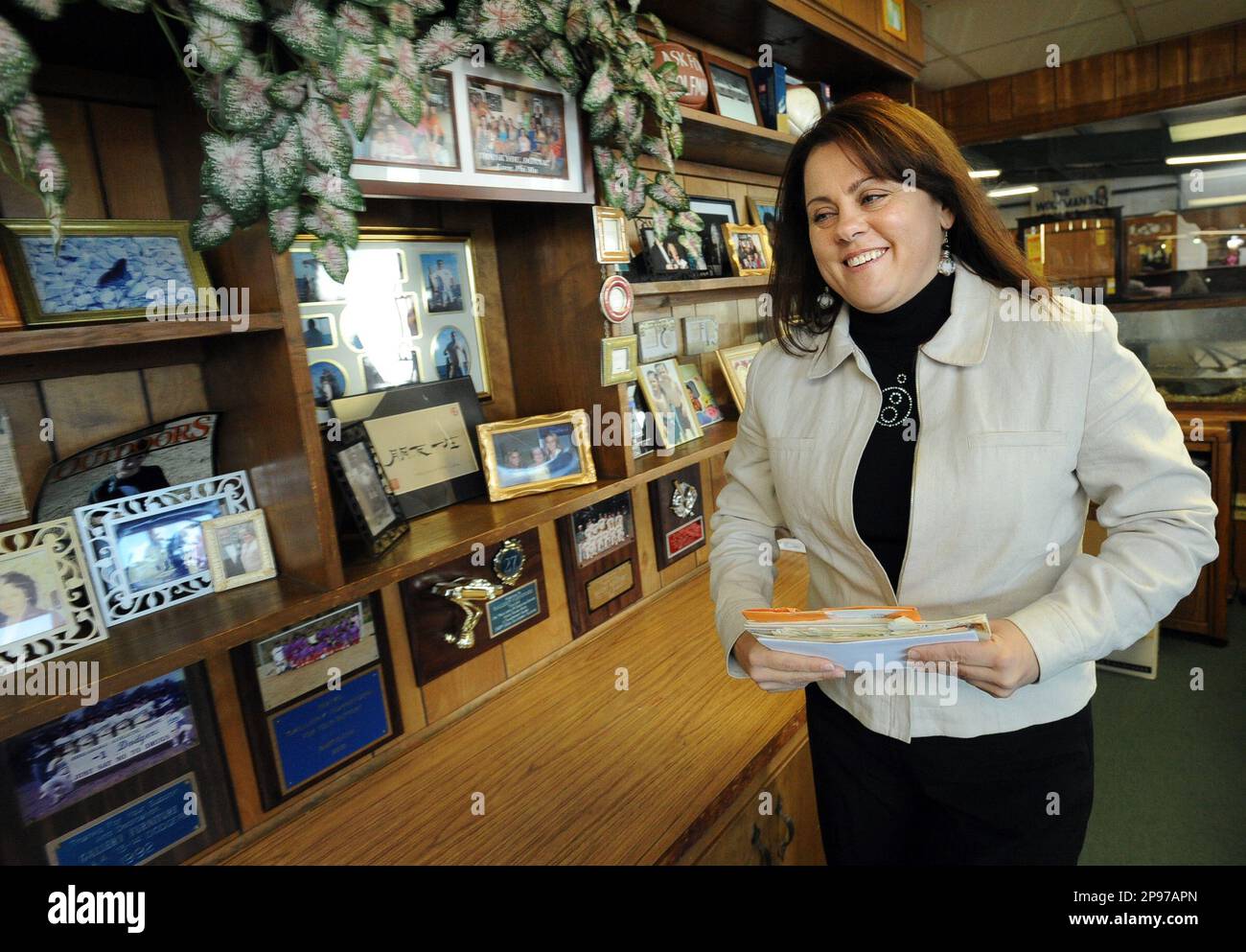 Donna Anderson holds letters from customers at Gallery Furniture in