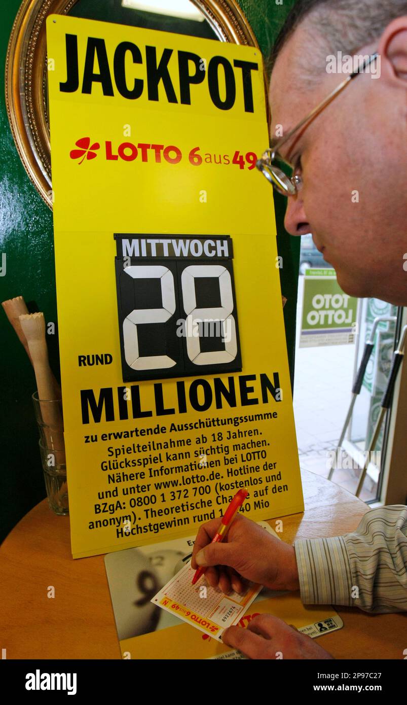 A man fills in a lottery ticket at a Lotto receiving office in Dortmund  October 6, 2006. This Saturday the German public lottery 'Lotto' will  distribute a total of around 35 million