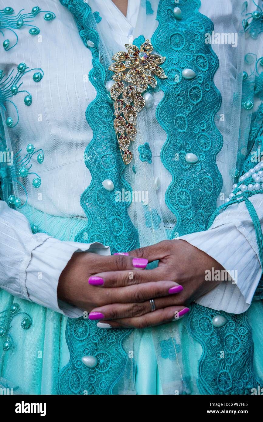 Benita la Intocable, detail of her dress and hands, cholita female