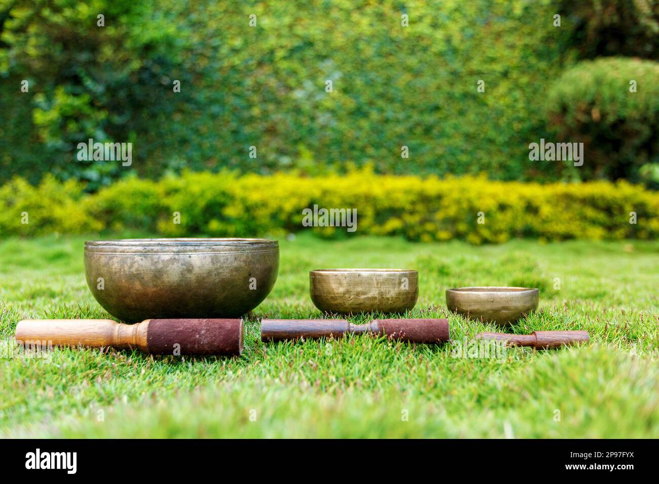 Ancient Tibetan singing bowls on green grass. Singing bowls for sound