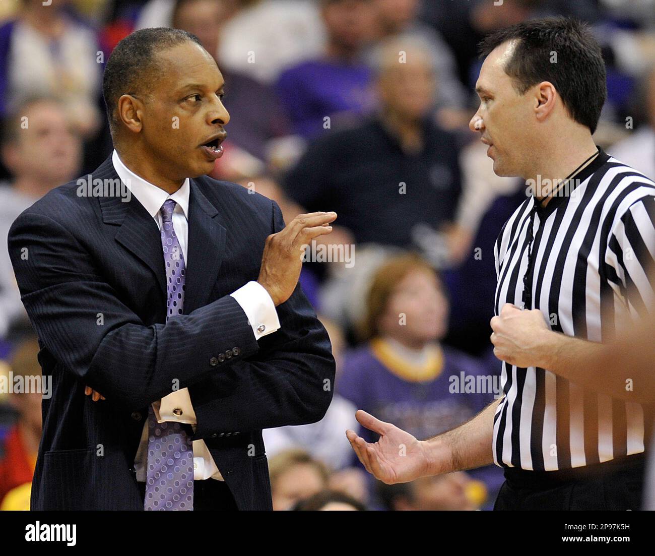 Louisiana State coach Trent Johnson, left, has a word with referee