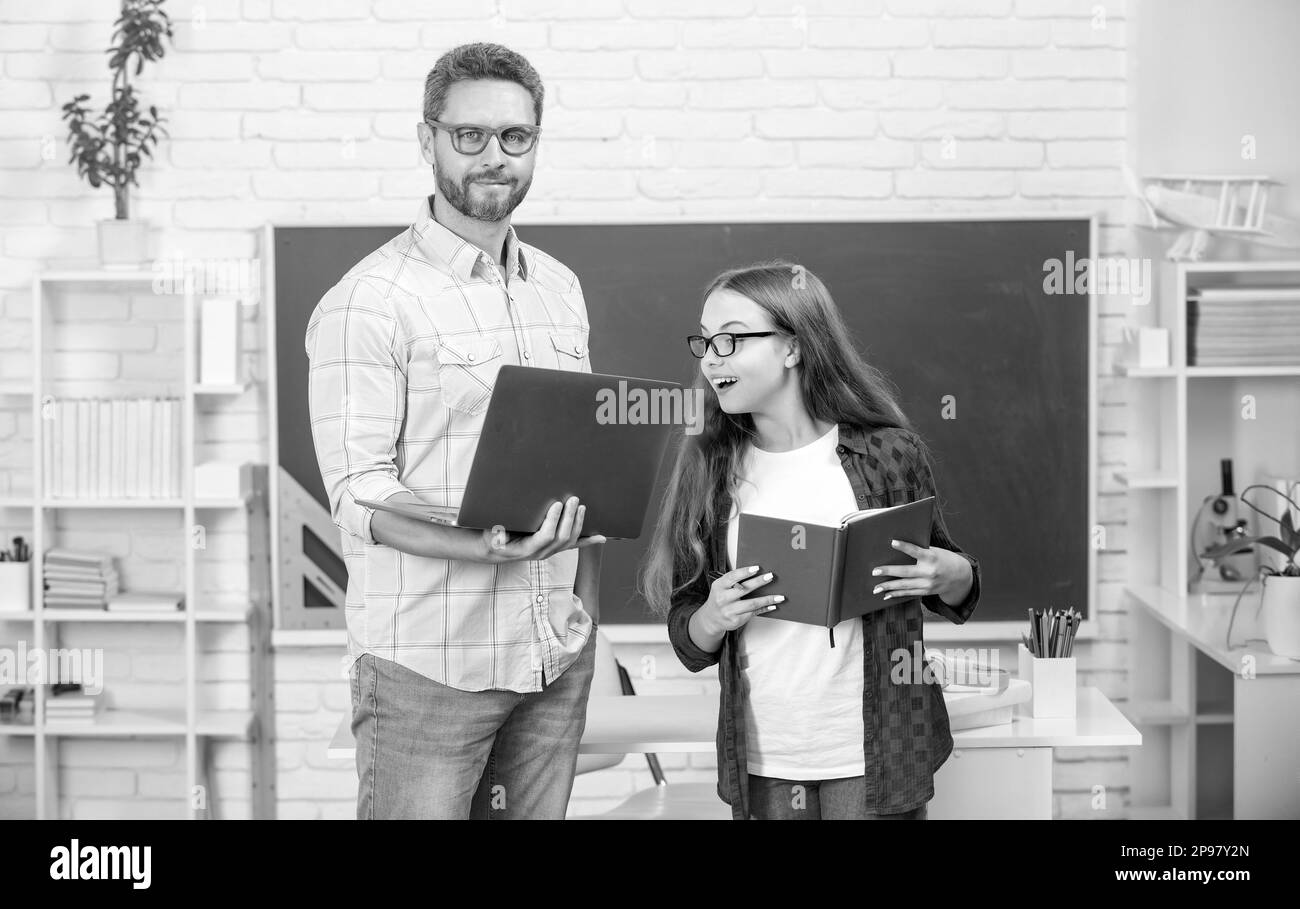 dad and daughter use notebook. back to school. childhood education