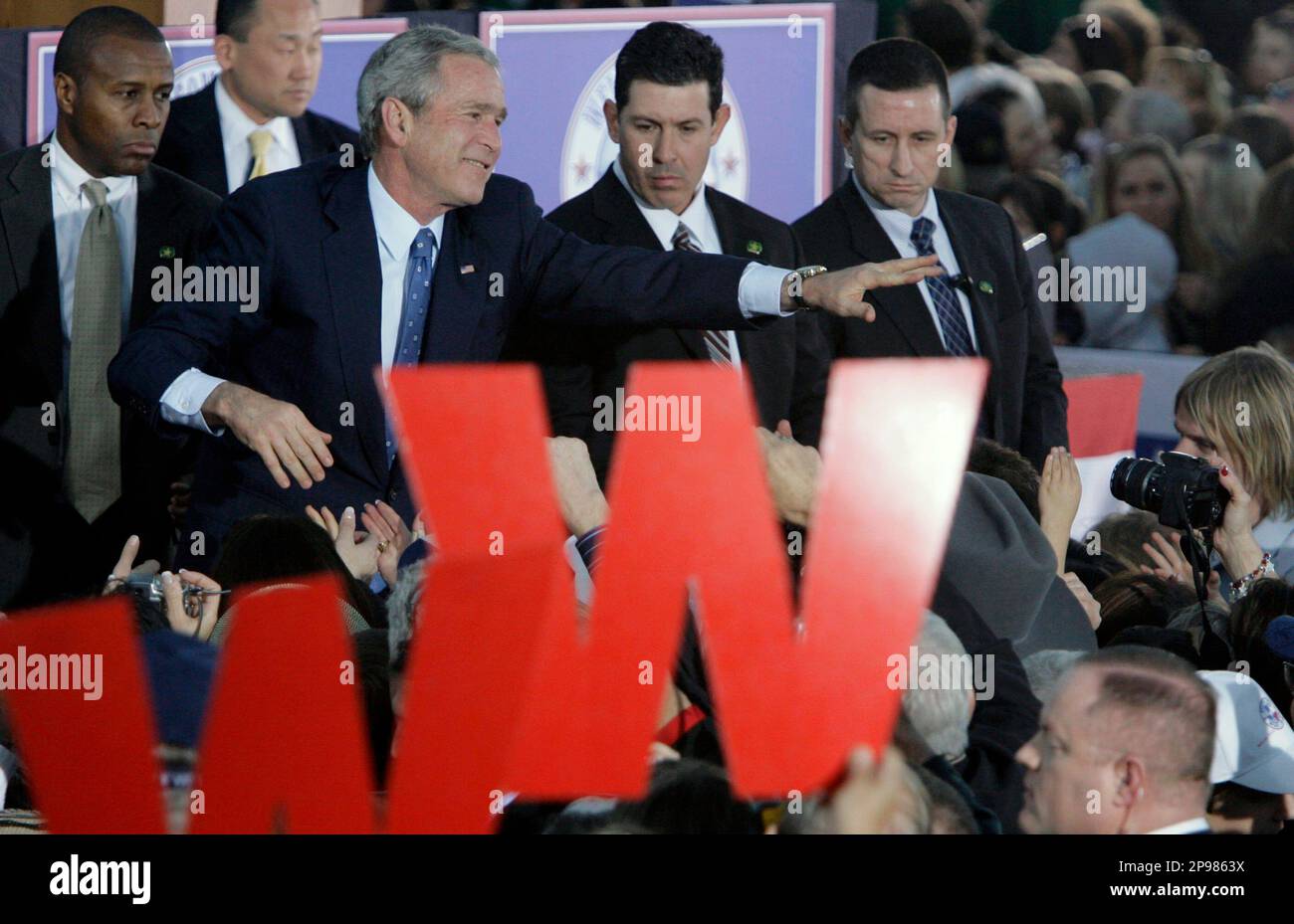 Former President George W. Bush waves to the crowd after a