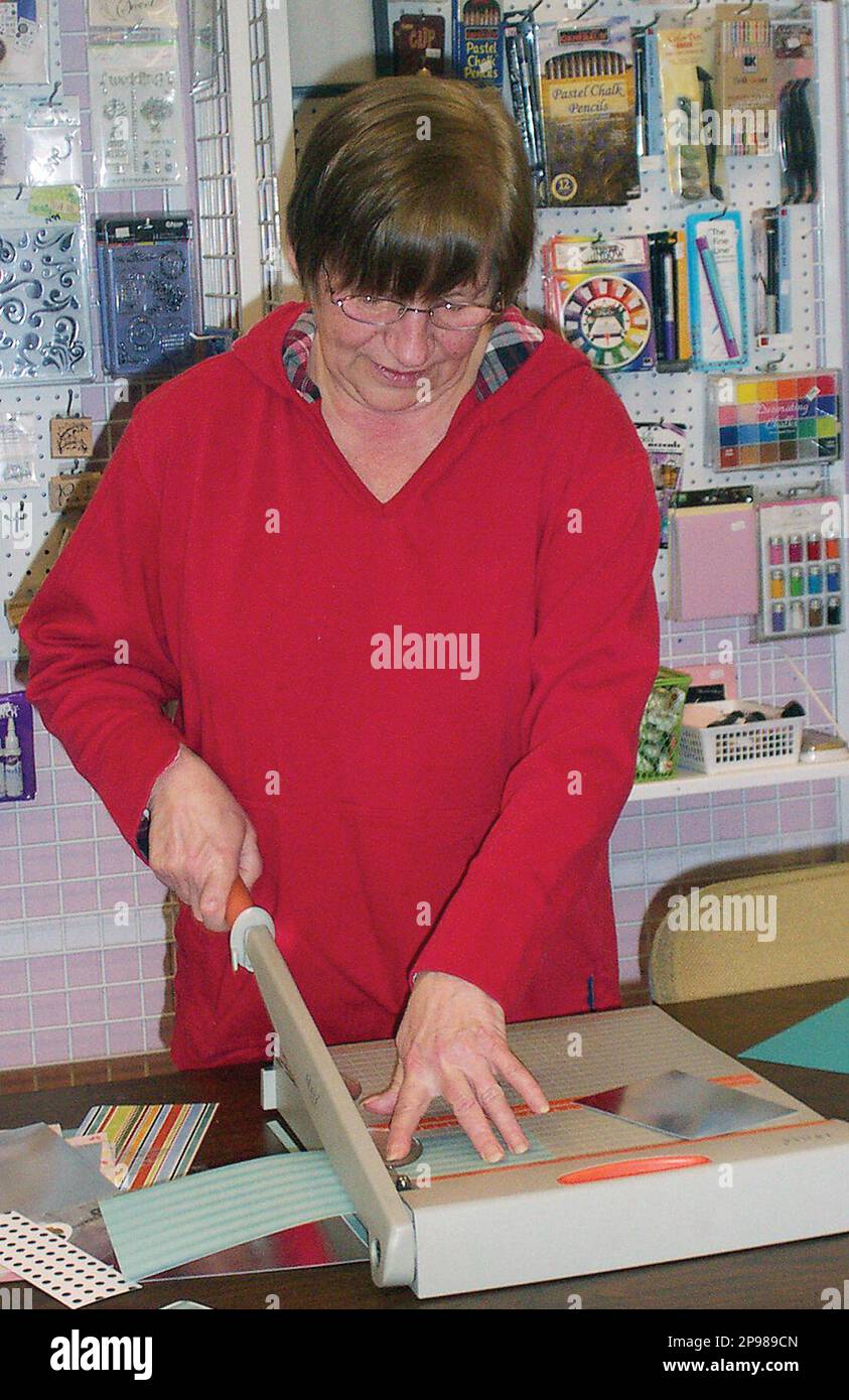 Pat Scarsella gathers materials to make homemade greeting cards. She