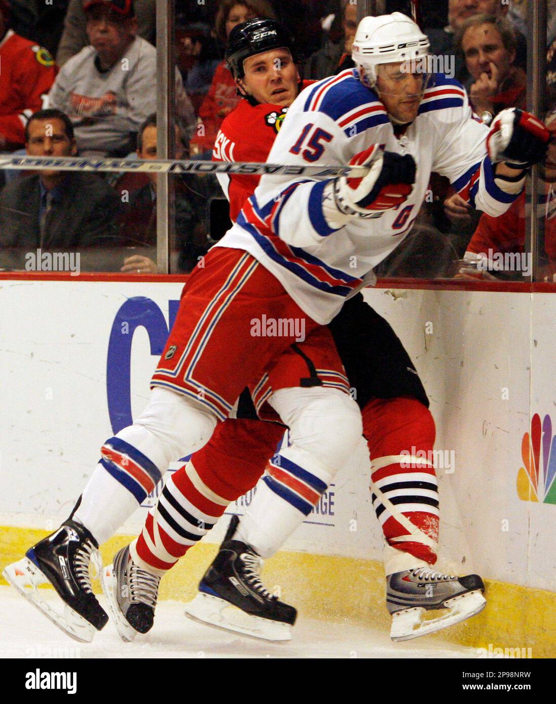 Chicago Blackhawks' James Wisniewski, left, is checked into the boards New  York Rangers' Blair Betts during the first period of an NHL hockey game,  Friday, Jan. 16, 2009, in Chicago.(AP Photo/Nam Y.