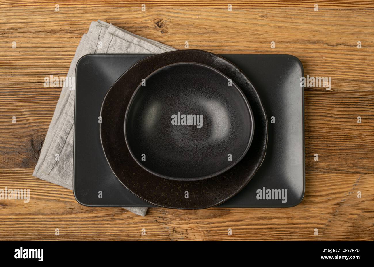 Empty Black Bowls and Plates on Wooden Table Background, Black Plate Mockup Top View, Rustic Kitchen Mock Up with Copy Space Stock Photo