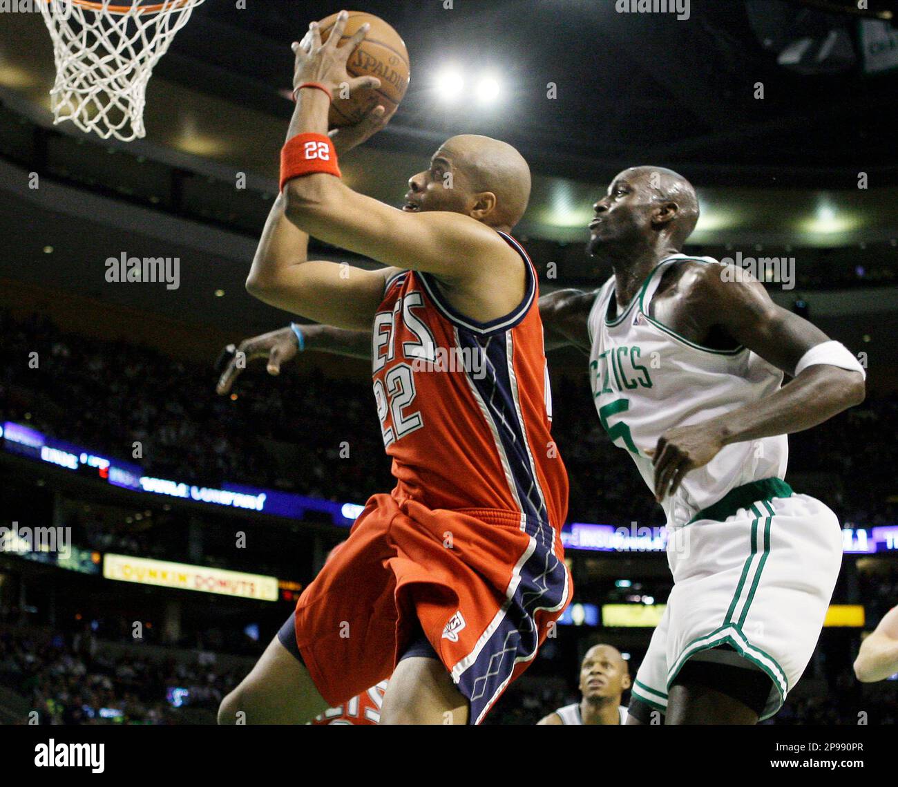 New Jersey Nets forward Jarvis Hayes (22) drives to the basket past Boston  Celtics forward Kevin Garnett (5) during the second half of an NBA  basketball game in Boston on Wednesday, Jan.