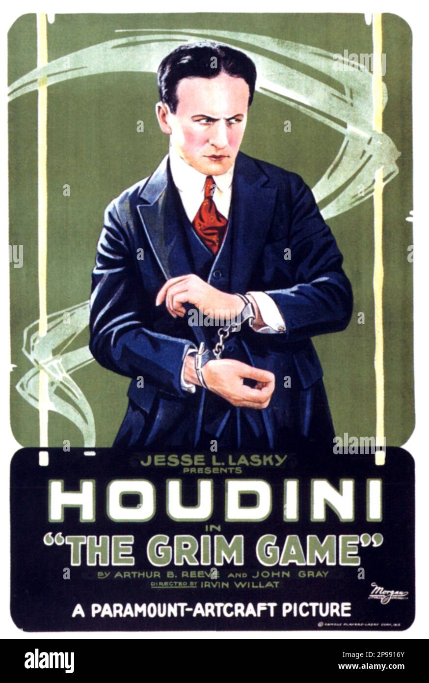 1919  : The most celebrated american magician HARRY HOUDINI ( 1874 - 1926 ) actor in THE GRIM GAME by Arthur B. reeve and John Gray  - Foto storica - historic photos - esperimento - escapologist - escapologism - escapologia - prestigitatore illusionista - ILLUSIONIST - ritratto - portrait  -  MOVIE - CINEMA - FILM - manette  ----   Archivio GBB Stock Photo
