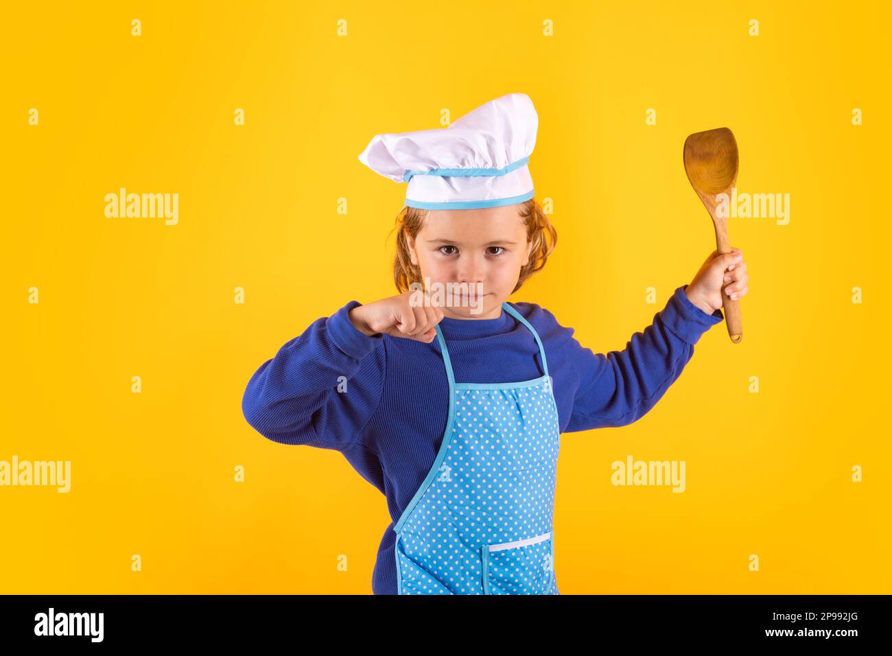Kid cook with cooking ladle. Kid chef cook prepares food on isolated