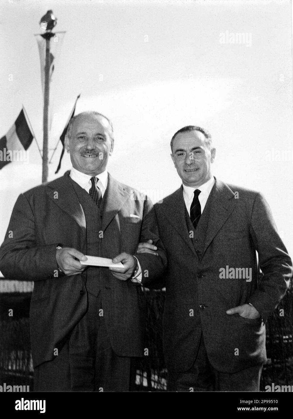 The italian politician ENRICO MATTEI  ( Acqualagna, 1906 - Bascape',  1962) was an Italian public administrator. In this photo ( at left ) with Ingenier Zannetti. Photo by Bazzecchi , Firenze . After World War II he was given the task of dismantling the Italian Petroleum Agency Agip, a state enterprise established by the Fascist regime. Instead Mattei enlarged and reorganized it into the National Fuel Trust Ente Nazionale Idrocarburi ( ENI ). Under his direction ENI negotiated important oil concessions in the Middle East as well as a significant trade agreement with the Soviet Union which help Stock Photo