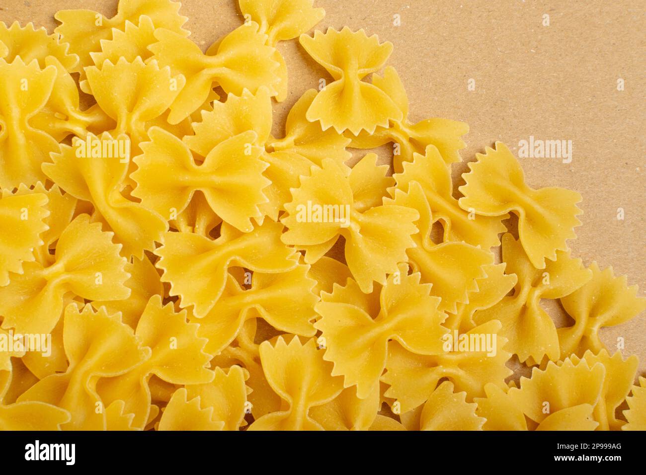 Raw Farfalle Pasta Texture Background, Yellow Dry Butterfly Noodles