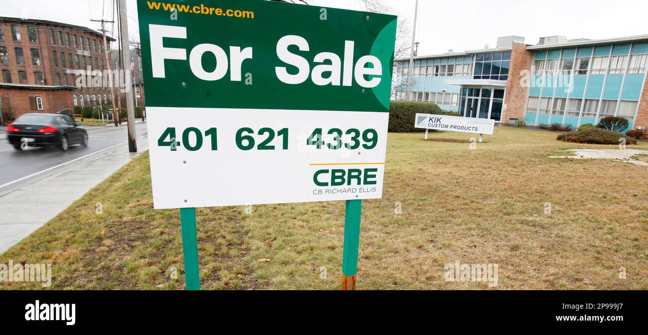 A for sale sign stands in front of a KIK Custom Products manufacturing  plant location, right, in Cumberland, R.I., Wednesday, Dec. 10, 2008. The  plant shut down in March of 2008, eliminating