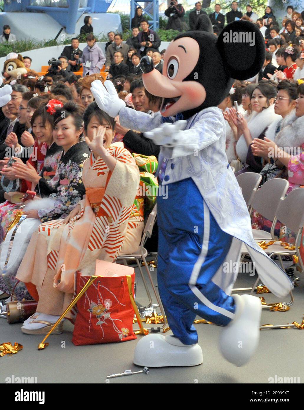 Mickey Mouse greets kimono-clad participants, who attain the age 