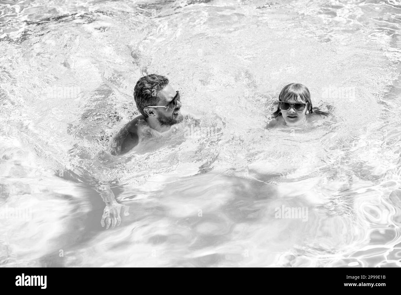 happy family of dad and kid having fun in summer swimming pool, summer holiday. Stock Photo