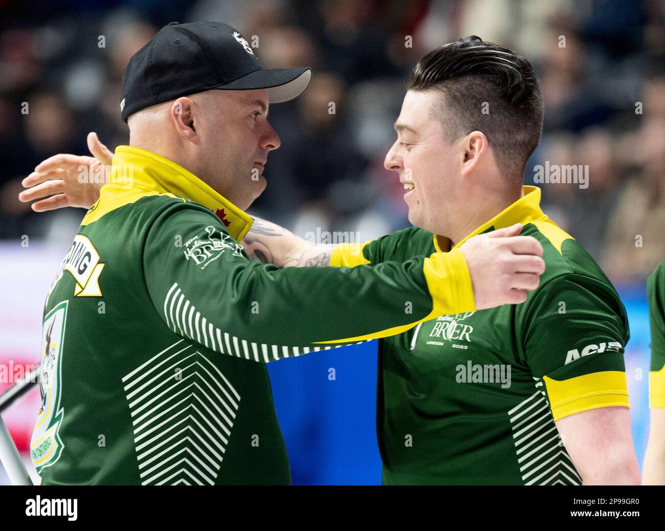 Northern Ontario's Darren Moulding hugs teammate Colin Hodgson after