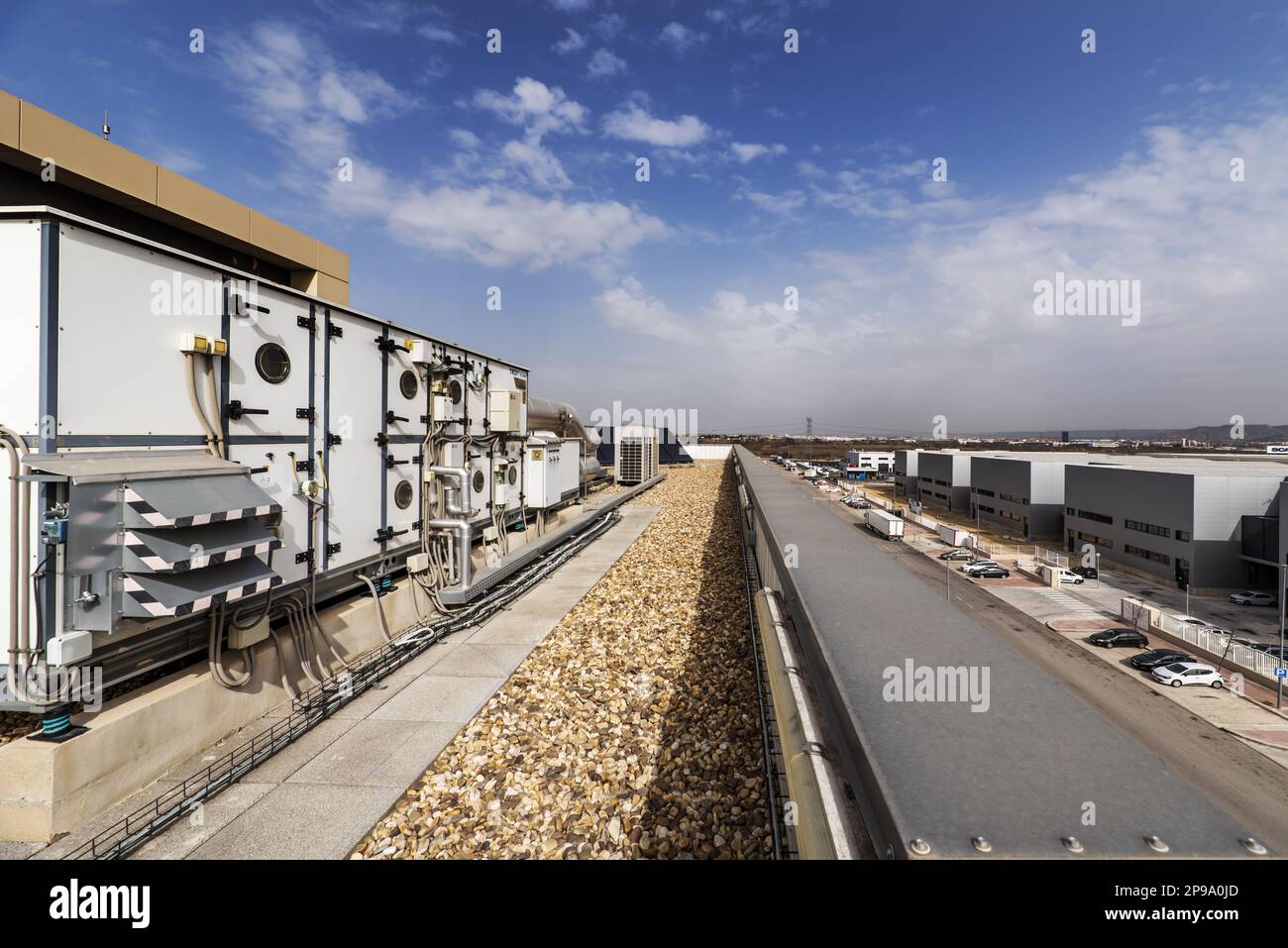 Rooftop of a factory building with air conditioning and air cleaning equipment and gravel-covered floors Stock Photo