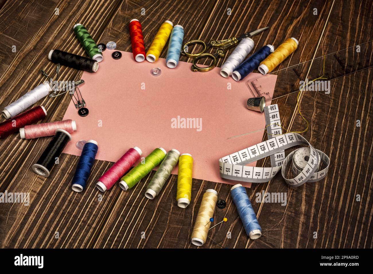 a sewing still life with a plastic ruler, tape measure, assorted