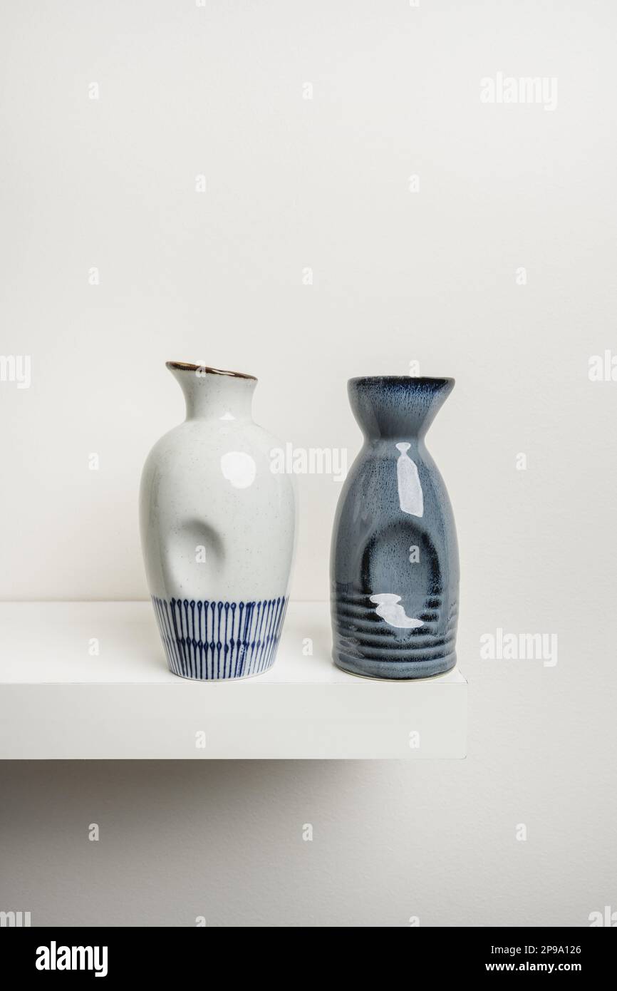 white shelf with some small white and blue porcelain bottles Stock Photo