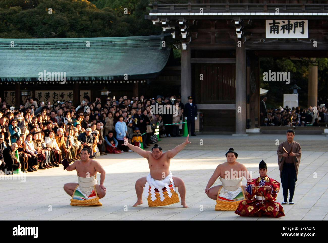 Sumo's grand champion Asashoryu, center, dedicates his ring entry forms ...
