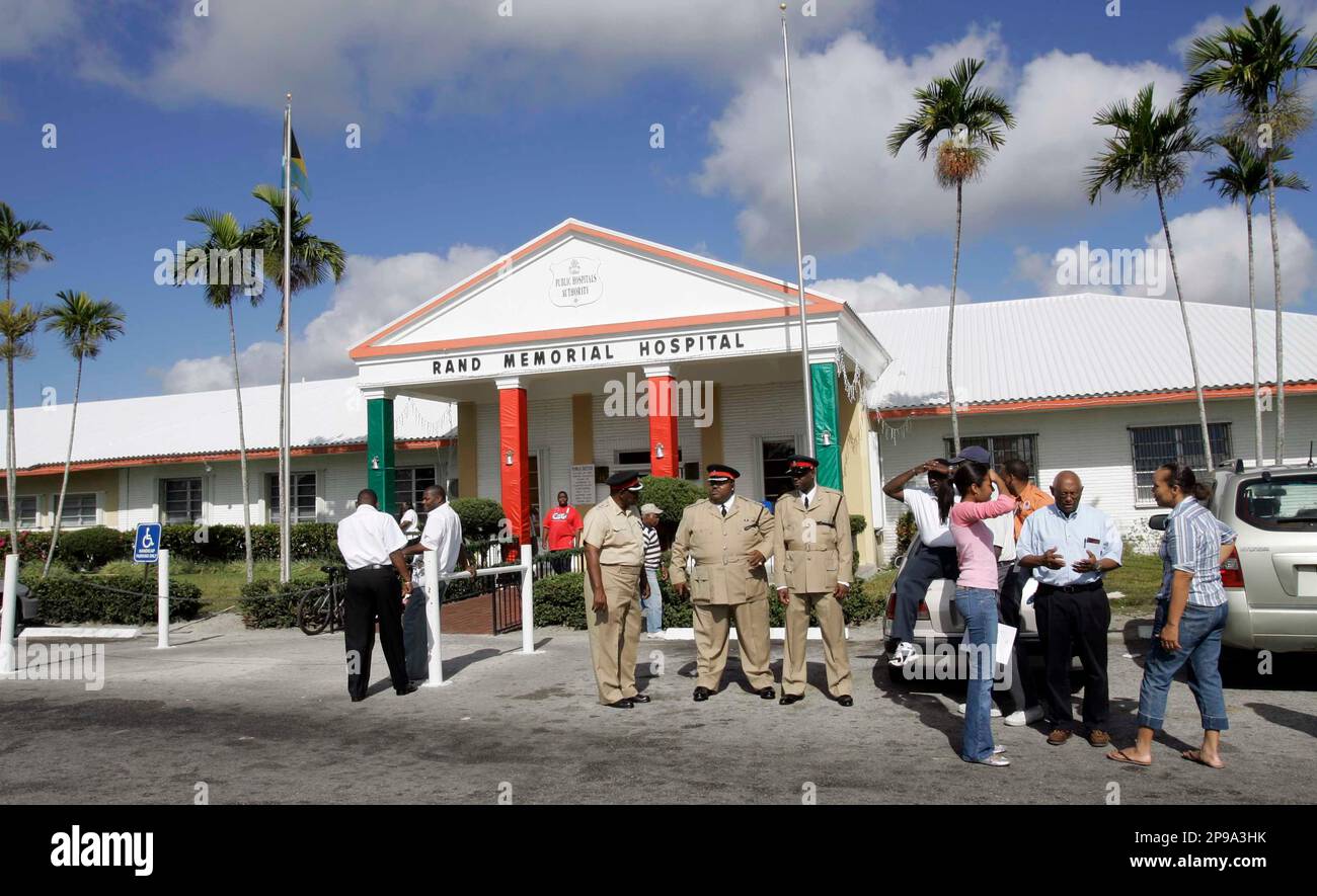 Grand Bahama police officers stand in front of the hospital where the