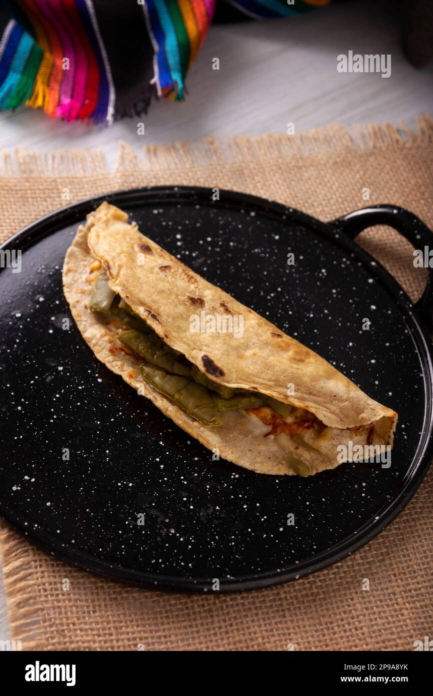 https://c8.alamy.com/comp/2P9A8YK/quesadilla-de-comal-con-queso-y-nopales-typical-mexican-quesadilla-made-on-a-comal-very-popular-dish-one-of-the-main-street-food-in-mexico-2P9A8YK.jpg