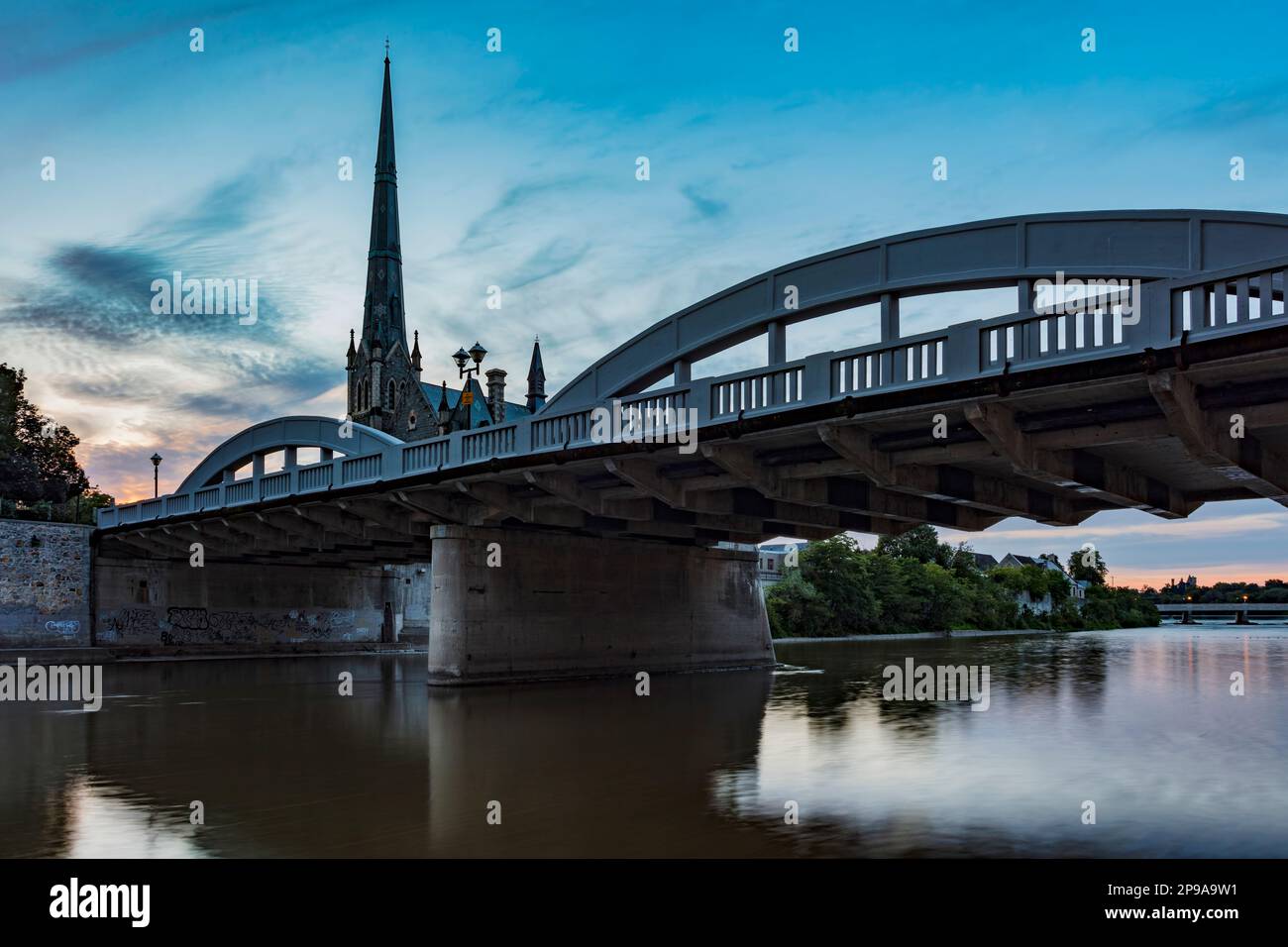What photographers call Blue Hour casts a serene hue over the Grand River at Cambridge, Ontario, Canada. Stock Photo