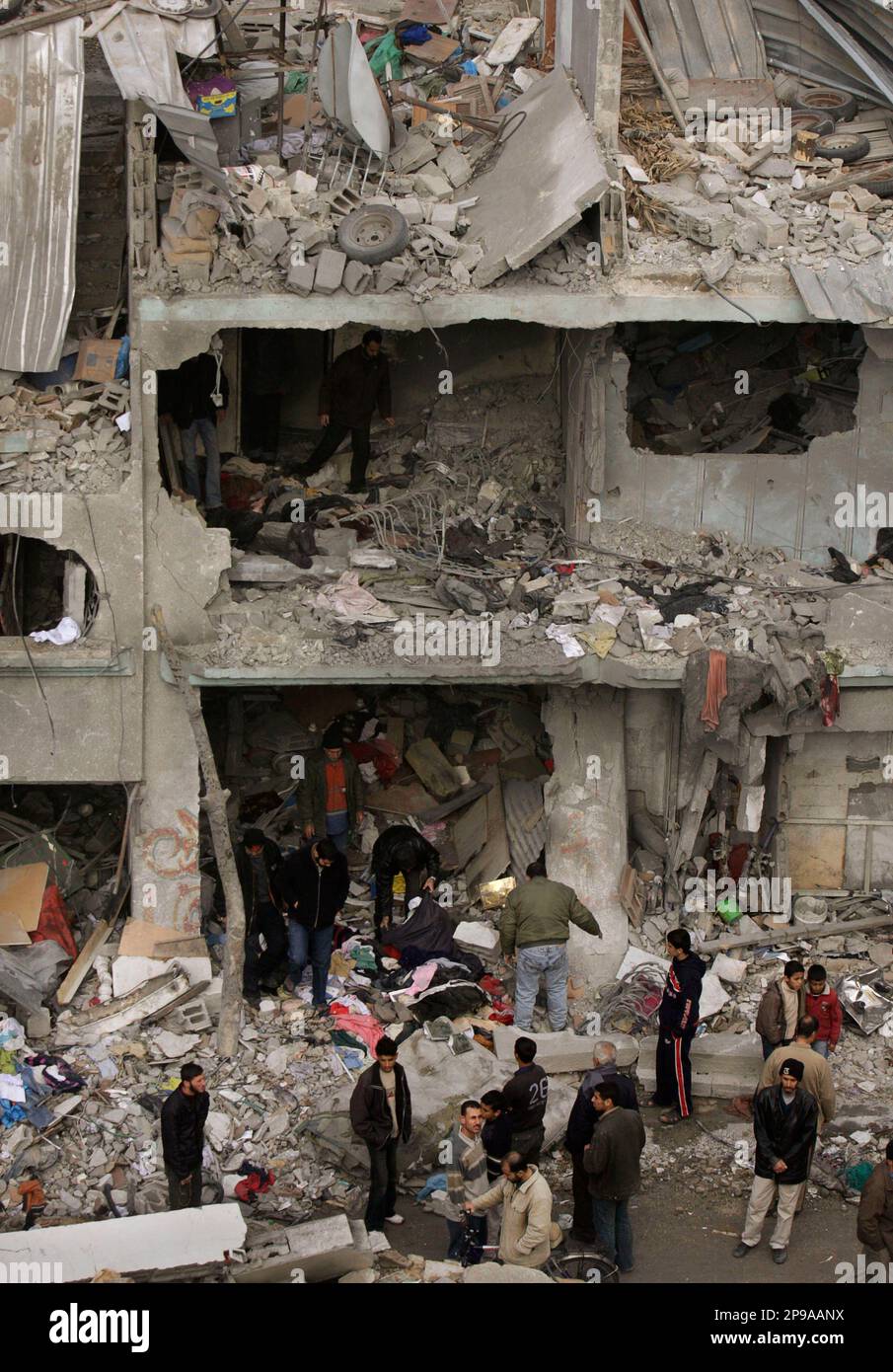 Palestinians Collect Belongings In The Rubble Of The Destroyed House Of ...