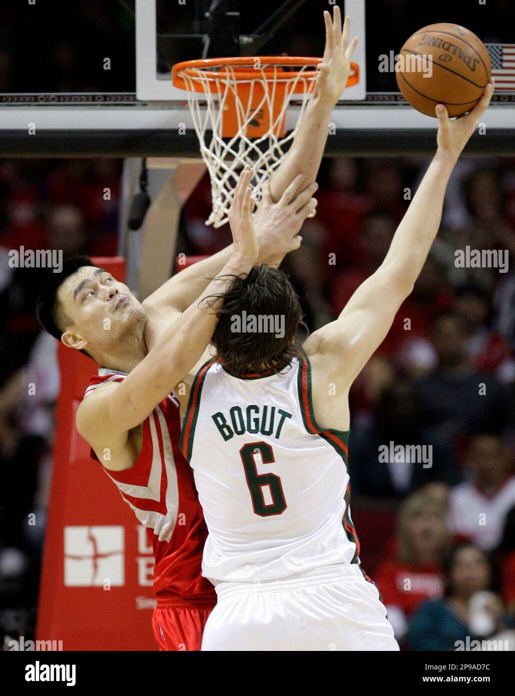 Milwaukee Bucks' Andrew Bogut (6), of Australia, goes up for a shot as  Houston Rockets' Yao Ming, left, of China, defends during the third quarter  of a NBA basketball game Wednesday, Dec.