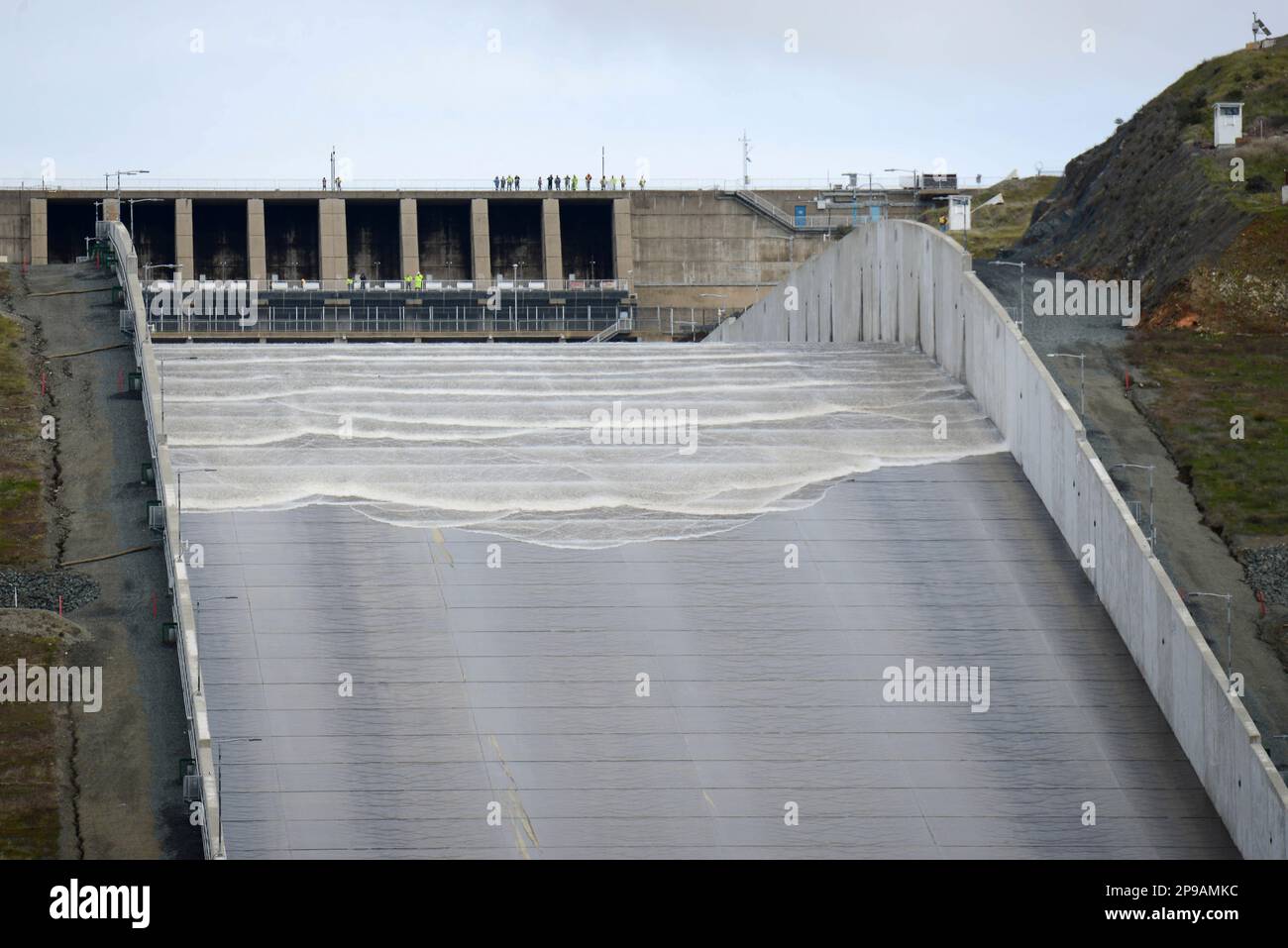 Water flows down Oroville Dam's main spillway in Oroville, Calif