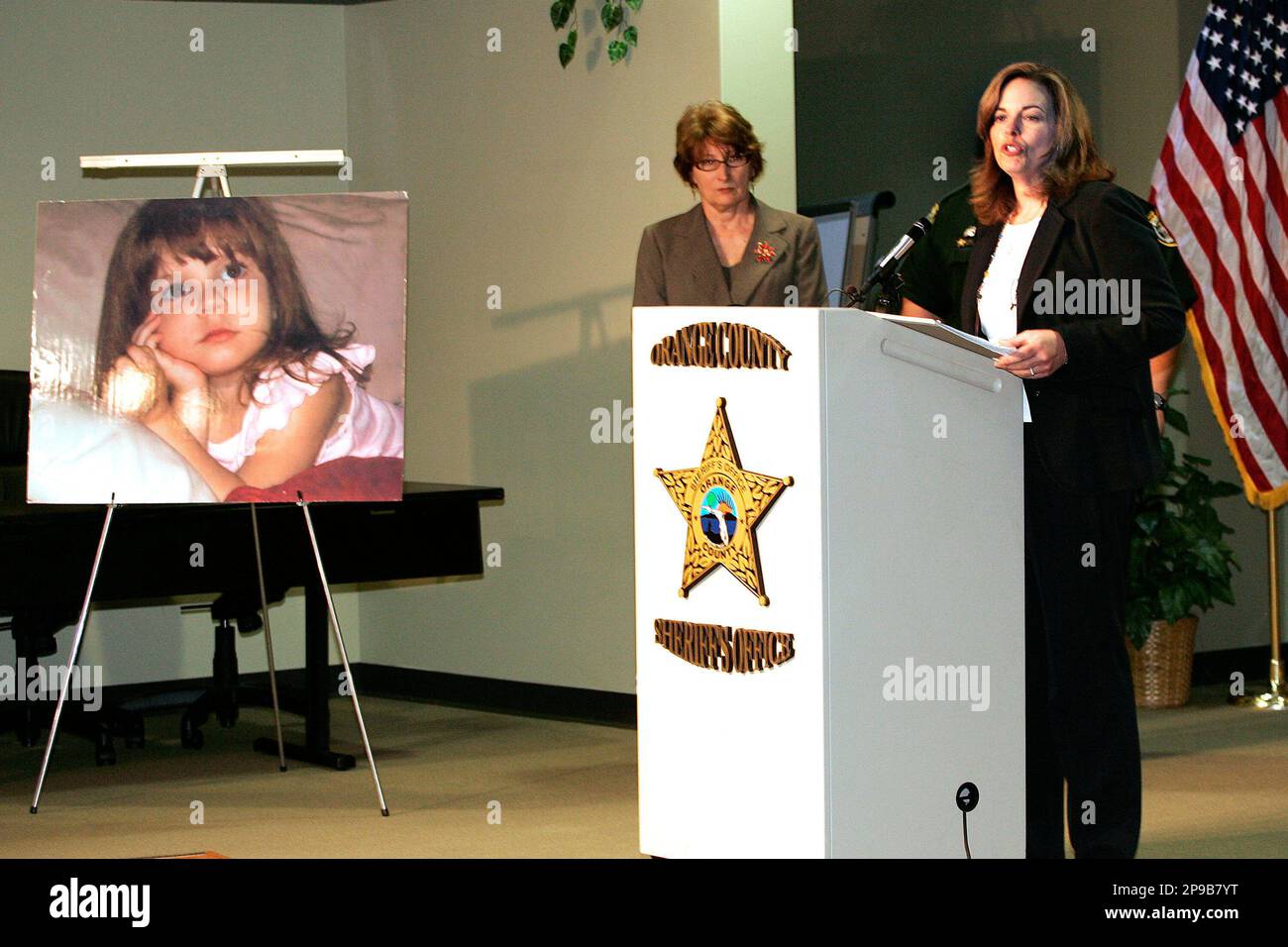 Joyce Dawley, left, of the Florida Division of Law Enforcement listens as Medical Examiner Dr. Jan Garavaglia announces that she has ruled the death or Caylee Anthony, shown in photo at left, a homicide after the bones found earlier were positively identified as that of the missing girl during a press conference in Orlando, Fla., Friday, Dec. 19, 2008. (AP Photo/Reinhold Matay) Stock Photo