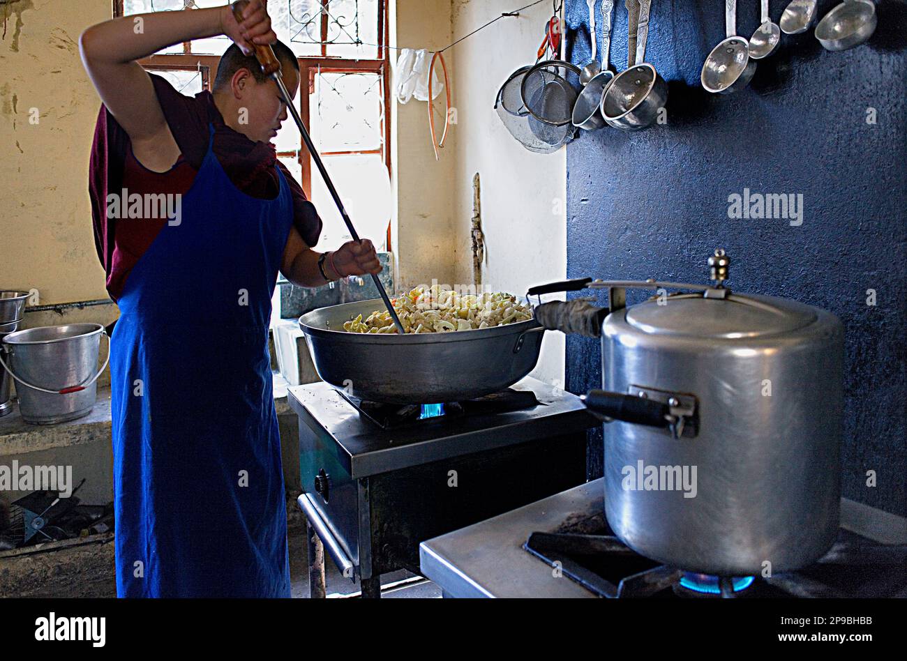 Nun cooking, in Geden Choeling Nunnery, McLeod Ganj, Dharamsala, Himachal Pradesh state, India, Asia Stock Photo