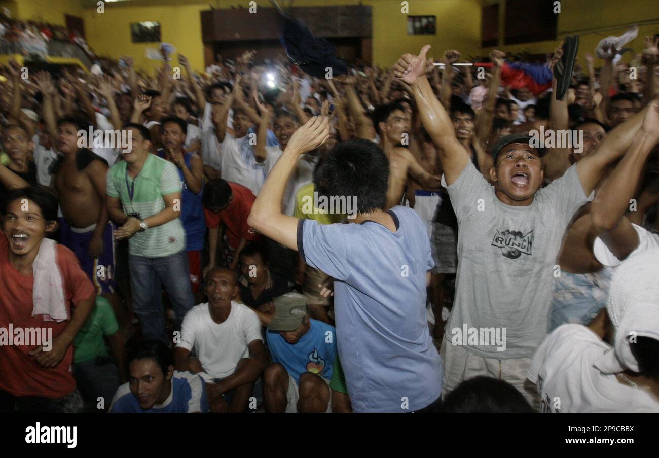Filipinos jubilate the victory of Filipino boxing icon Manny Pacquiao over Mexican Oscar De La Hoya while they watch it beamed live via satellite at the Tondo Sports Complex in Manila, Philippines