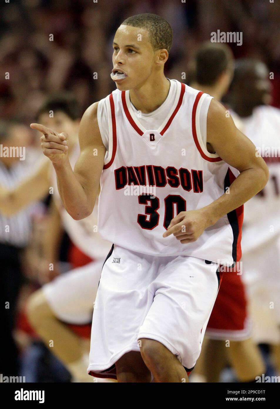 Davidson's Stephen Curry (30) points upward after scoring a basket