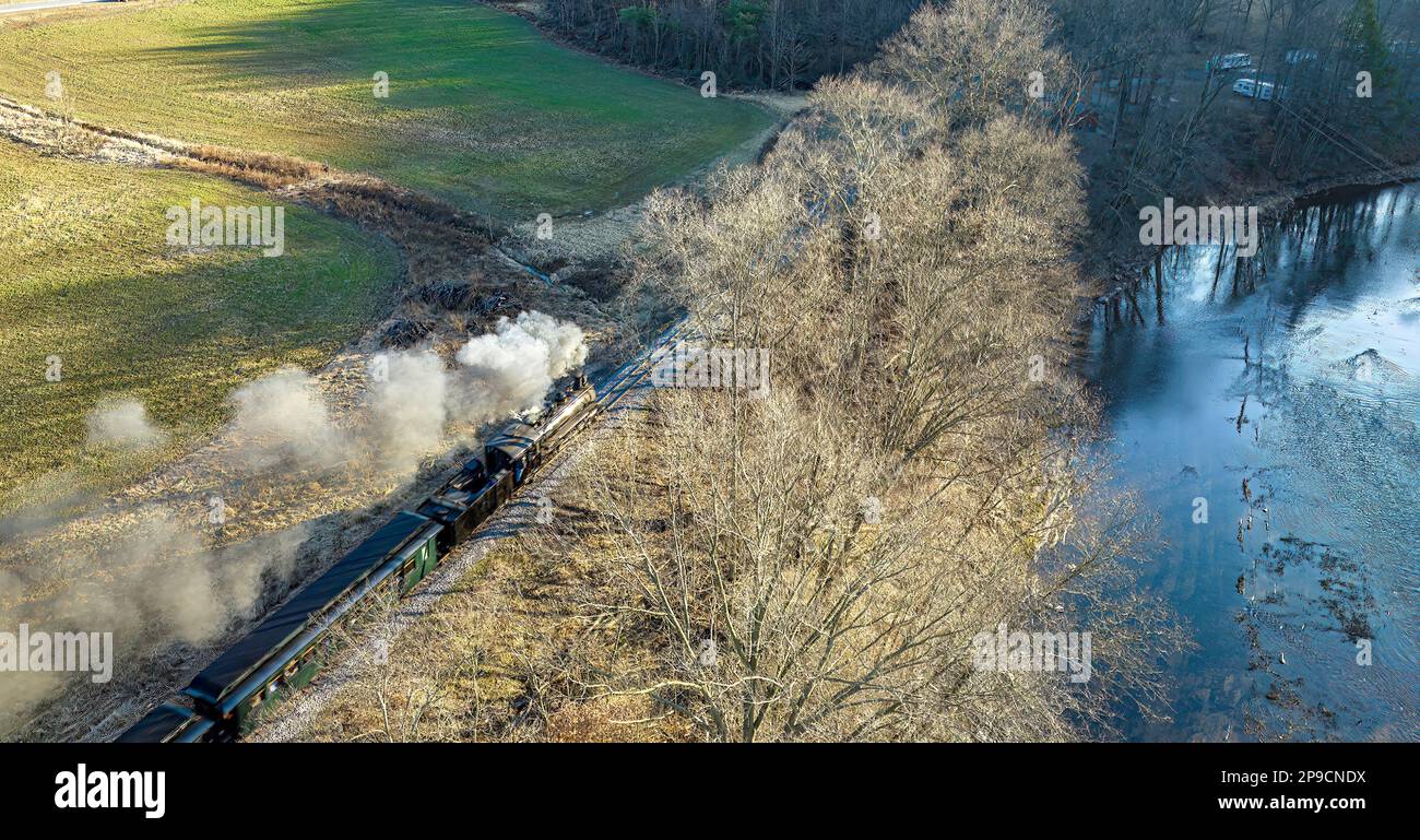 A Behind Aerial View of a Narrow Gauge Steam Passenger Train Traveling ...
