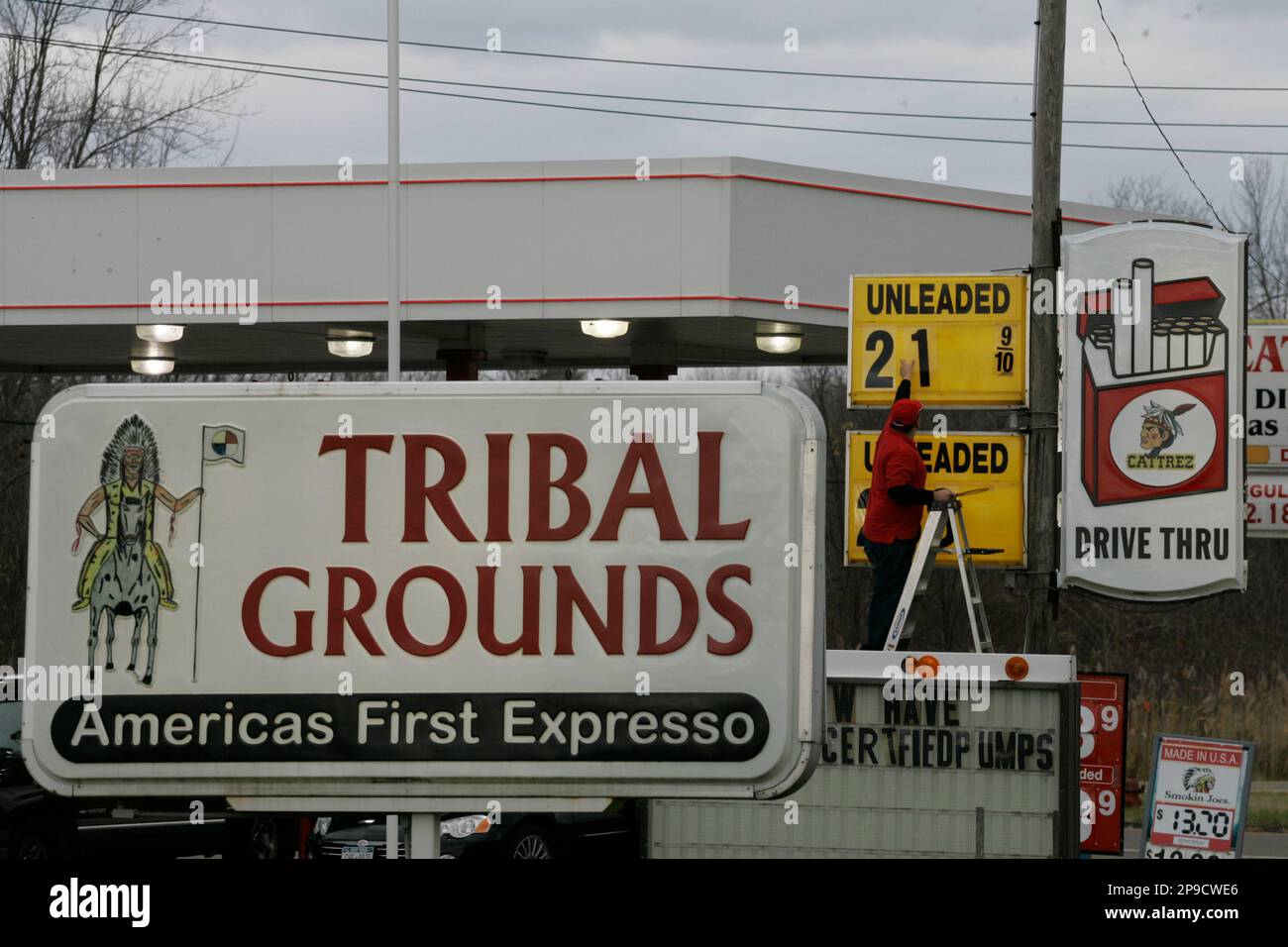 Dakota Snyder lowers the price of unleaded gasoline at the Catt-Rez  Enterprises gas station on the Cattaraugus Indian Reservation, in N.Y.,  Tuesday, Nov. 11, 2008. With the state a signature away from