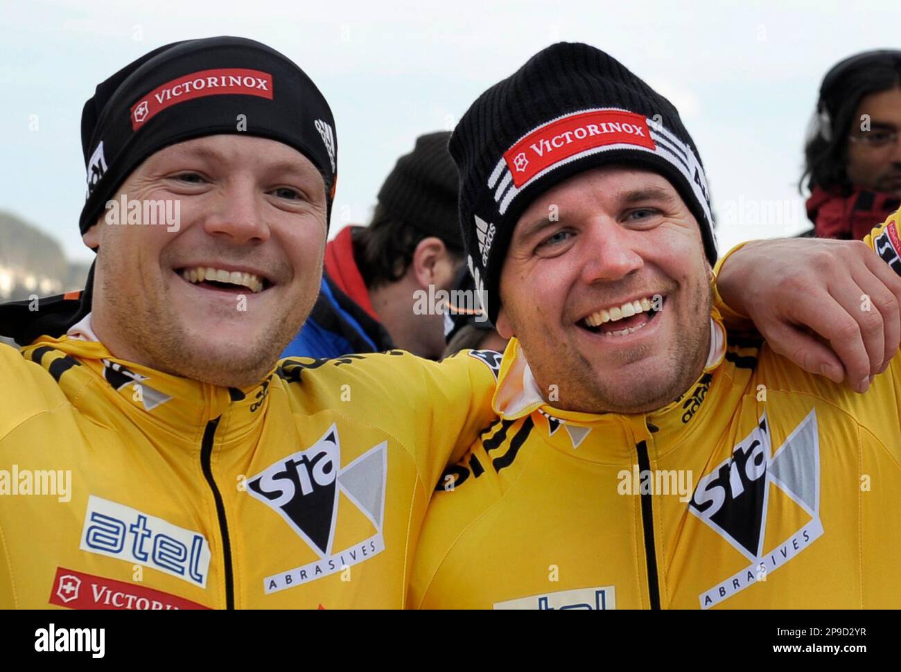 Switzerland's Beat Hefti, right, and his brakeman Thomas Lamparter, left,  celebrate after they finished the second run in men's two-man bobsleigh  FIBT World Cup opens in Winterberg, Germany, on Saturday, Nov. 29,