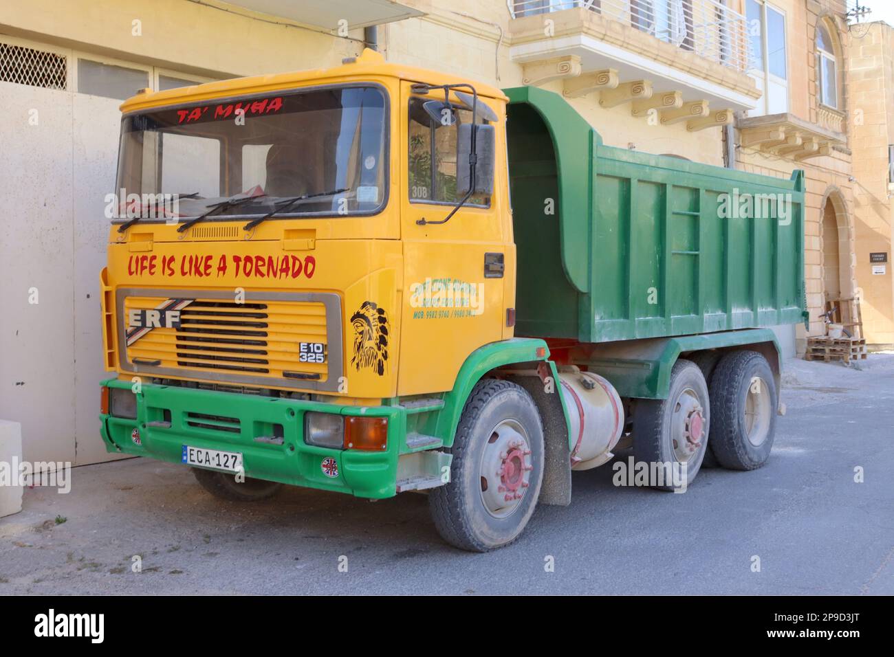 A vintage ERF E10 325 tipper truck cooling off from the Mediterranean heat after a days work, parked outside a private house in Xaghra, Gozo, Malta. Stock Photo