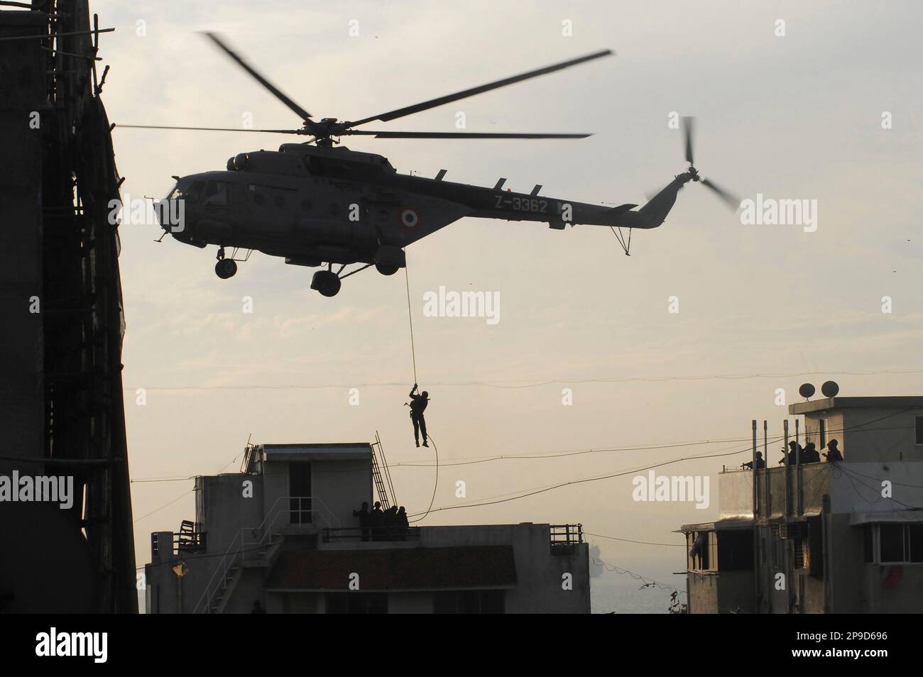 Indian commando comes down a rope to reach the top of Nariman House, a ...
