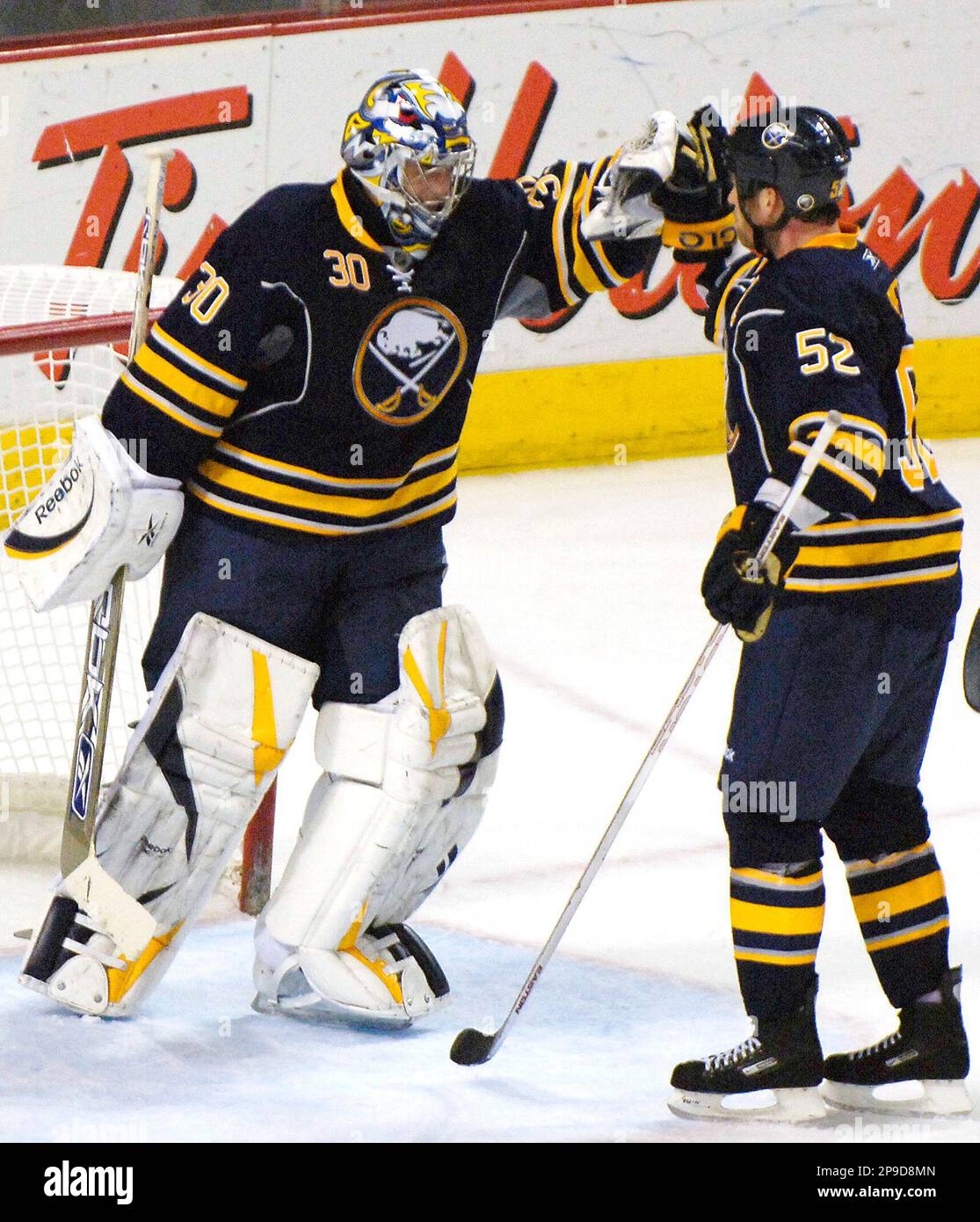 Buffalo Sabres goalie Ryan Miller, left, is congratulated by defenseman ...